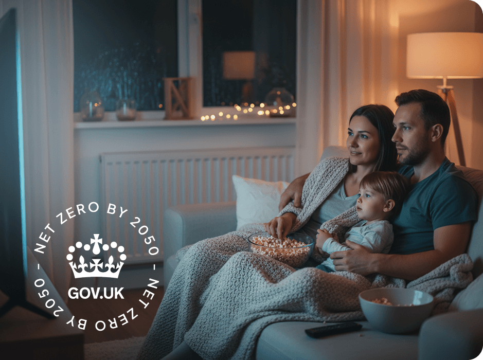 A family of three on the sofa enjoying a movie with a radiator in the background